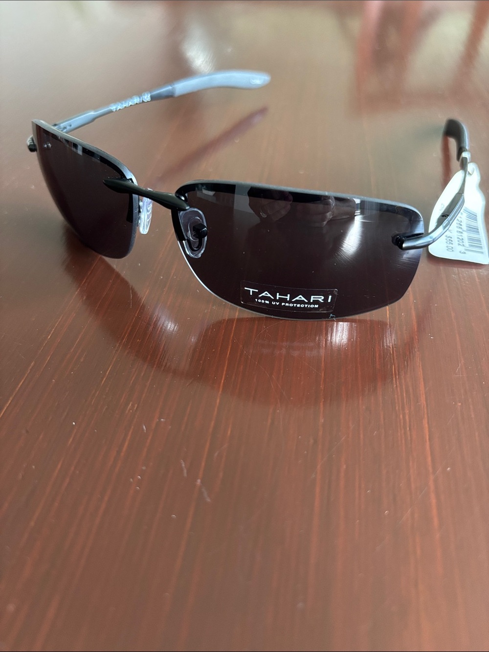 Tahari 100% UV protect,metal arms,rimless,oval/rectangke ,black mirror lens